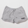 A heathered grey fleece sweat shorts feature "TMU" on the left leg, printed in black.