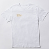 A short-sleeved white t-shirt features a printed "Toronto Metropolitan University" small stacked wordmark logo on the front right chest in embroidered metallic gold.