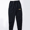 A black fleece sweatpants features "TMU" on the left hip, embroidered with gold metallic thread.