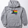 A heathered grey pullover fleece hoodie features the Pride Progress flag with a small right set TMU in white.