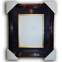 A vertical dark brown certificate frame with a navy blue background insert and gold trim around the degree placement. A gold university crest appears on the centre top of the blue background insert. Ryerson University text appears in gold on the centre bottom of the navy blue background insert.