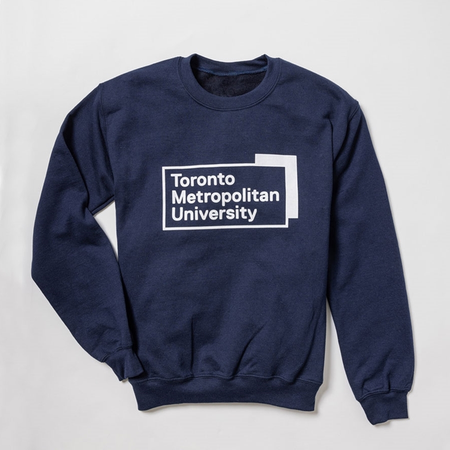 A navy pullover fleece crew neck sweatshirt features the "Toronto Metropolitan University" university logo, printed front & centre in white.