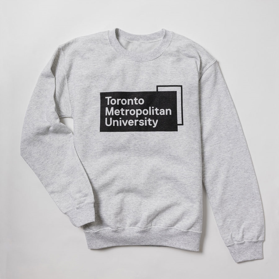 A grey pullover fleece crew neck sweatshirt features the "Toronto Metropolitan University" university logo, printed front & centre in black.
