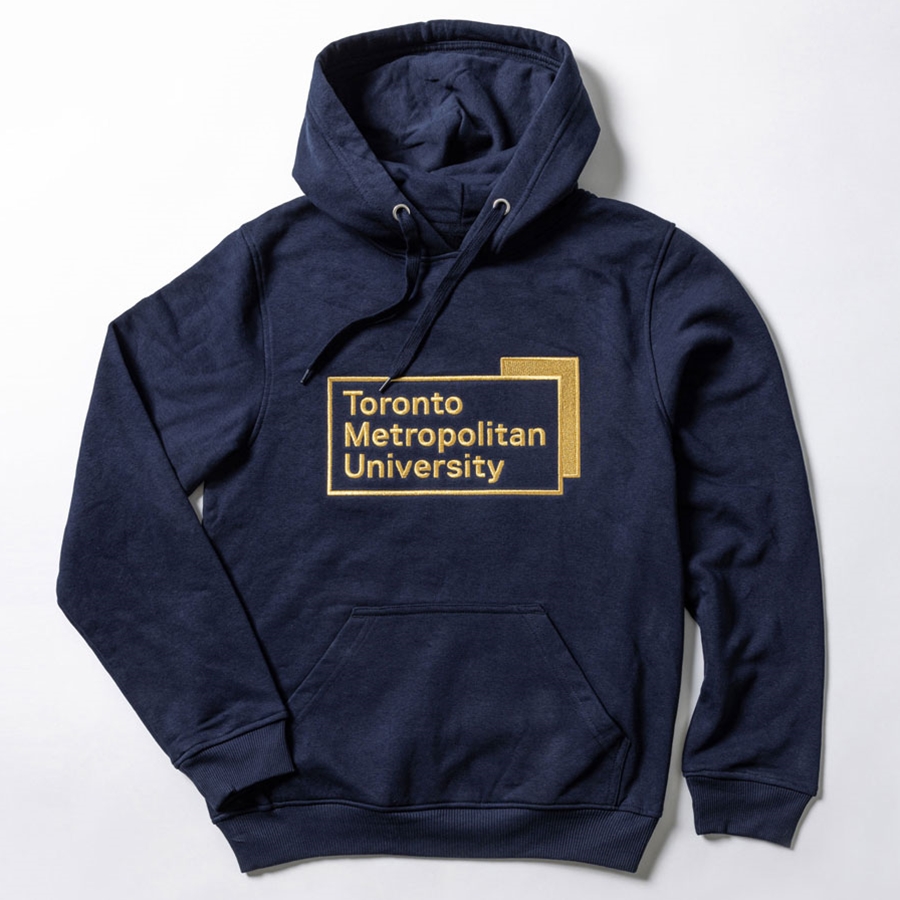 A navy pullover fleece hoodie features the "Toronto Metropolitan University" corporate logo, embroidered in gold metallic thread, front and centre.