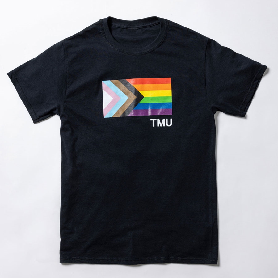 A short-sleeved black t-shirt features the Pride Progress flag with a small TMU in white.